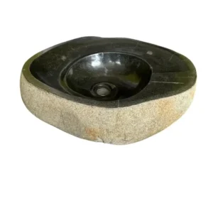 Handcrafted natural river stone sink with polished black interior and raw outer texture.