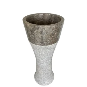 Two-tone marble sink pedestal with polished dark upper section and textured light base, tapered cylindrical design.