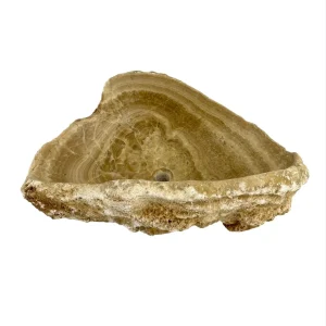 Natural onyx bathroom sink with polished interior and rustic raw stone exterior