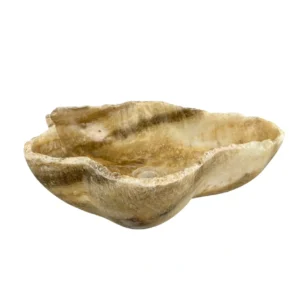 Natural onyx bathroom sink with polished interior and rustic raw stone exterior
